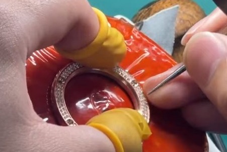 Hand-setting Zirconia Stones Onto the Watch Bezel